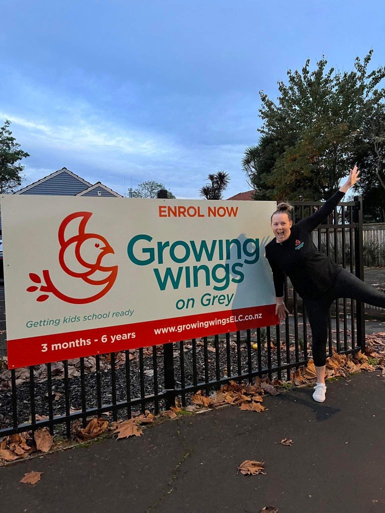 Becks day one in front of sign